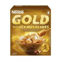 Готовый завтрак Nestle Gold Honey Nut Flakes. Хлопья кукурузные с медом и арахисом, обогащенные витаминами